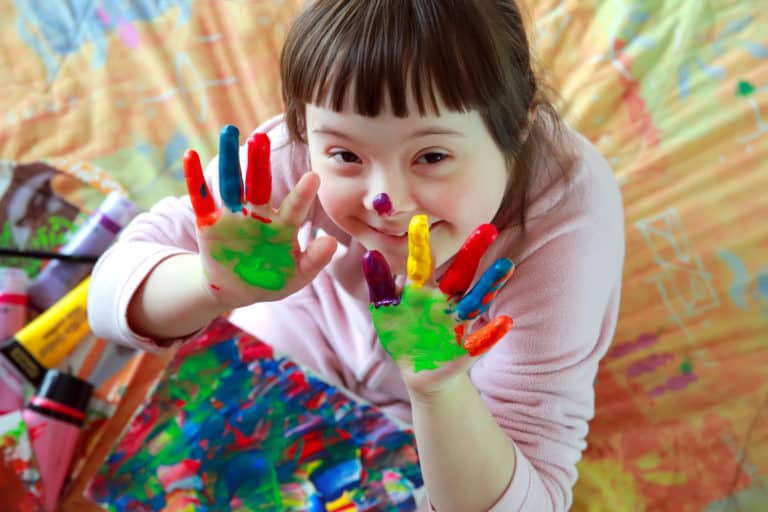 Cute little girl with painted hands