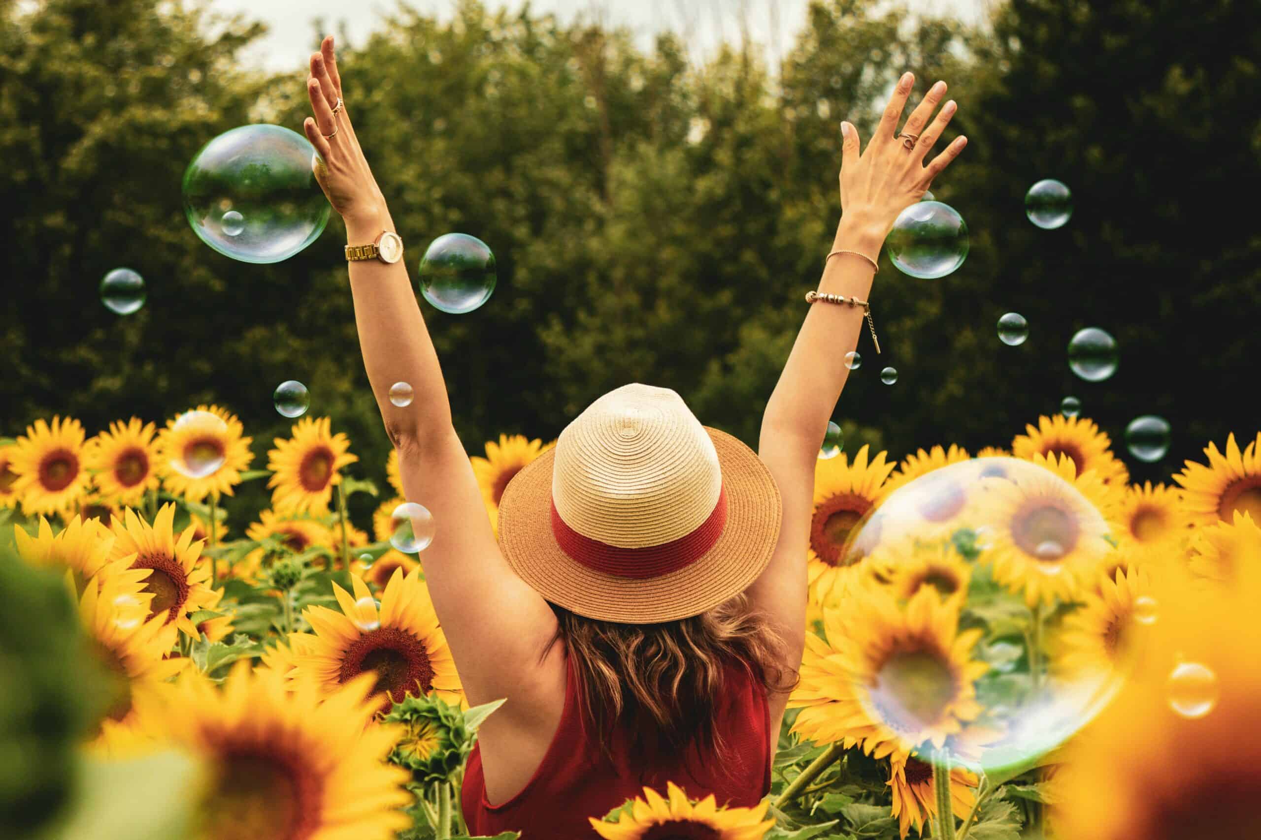 woman with a sun hat in a sunflower patch