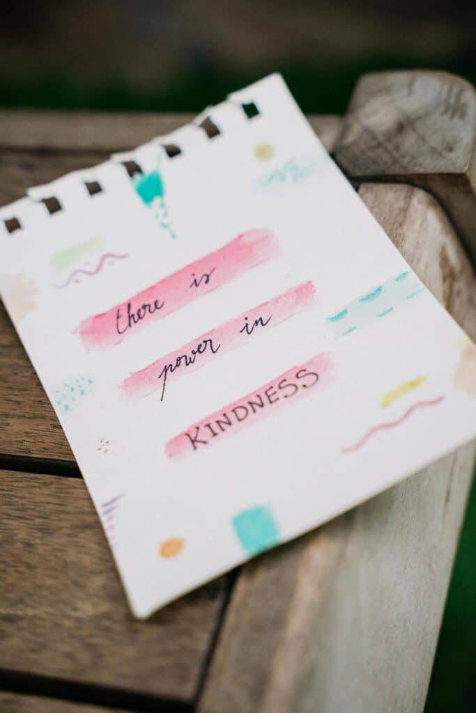 Colourful note that reads 'There is power in kindness'