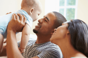 a mum, dad and baby happy